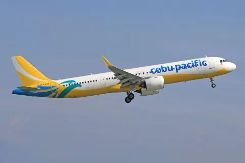 Cebu Pacific aircraft flying against a clear blue sky